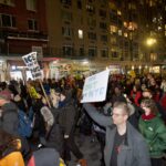 A crowd protests the murder of Renee Goode by an ICE agent