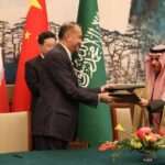 Iranian Foreign Minister Hossein Amir-Abdollahian and his Saudi counterpart, Prince Faisal bin Farhan Al Saud after signing a joint statement on the restoration of diplomatic relations, with Chinese Foreign Minister Qin Gang in the background.