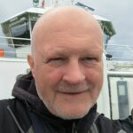 A headshot of Daniel Nicholls